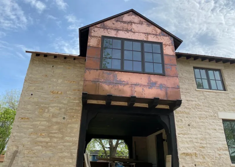 Copper metal panel facade on a stone building for Skylight Installation in Florin