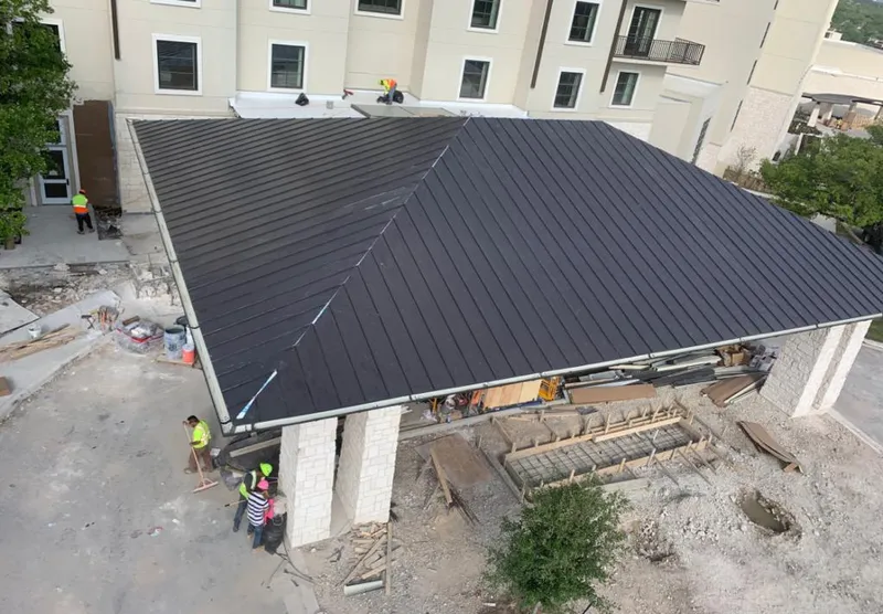 Metal roofing installation team working on a commercial building in Florin
